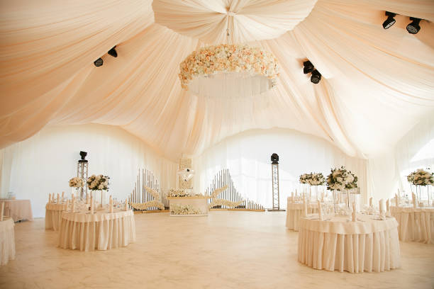 Luxurious high tent decorated for wedding celebration.